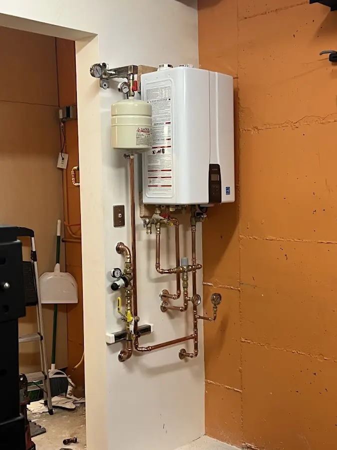Plumbing technician inspecting water heater connections in Rocklin